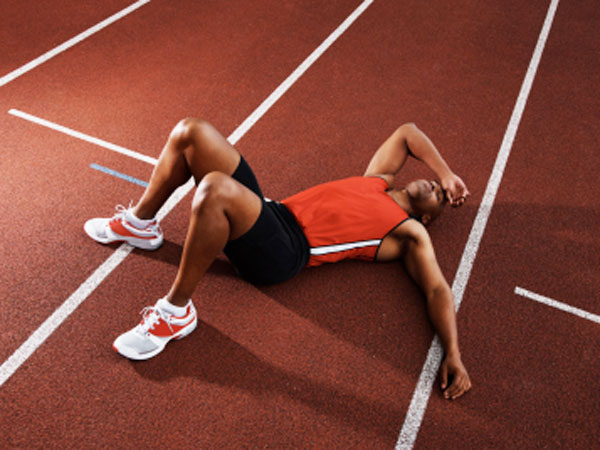 Runner laying down on track