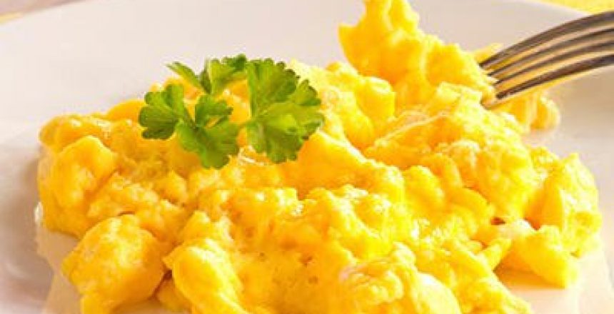 Scrambled eggs with a sprig of parsley on top