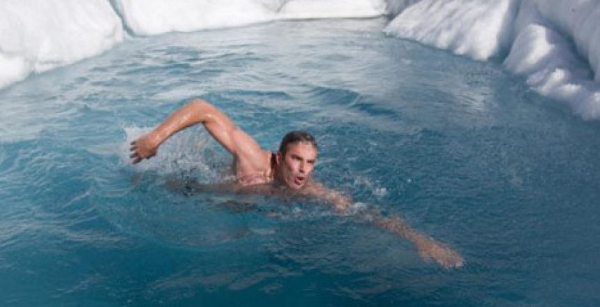 Man swimming in cold glacier area