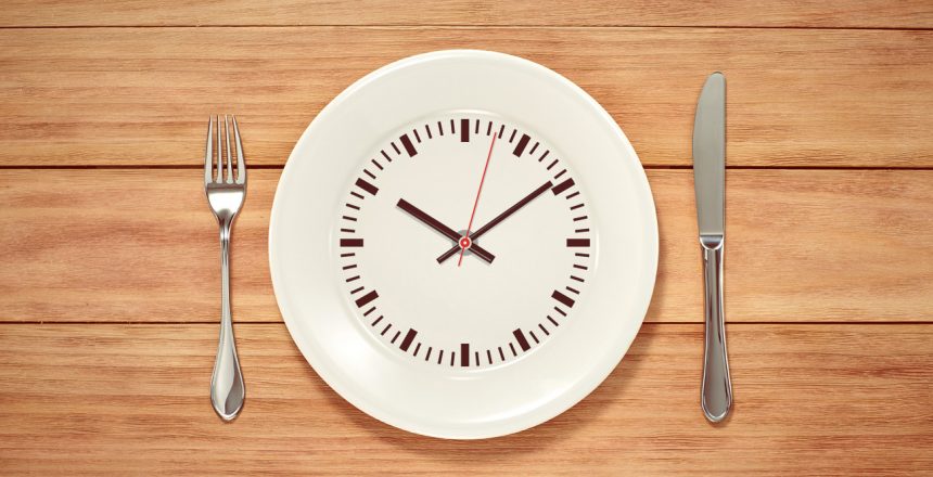 clock printed on a plate next to a fork and knife